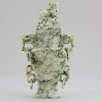 A carved green stone vase with cover, China, 20th Century.