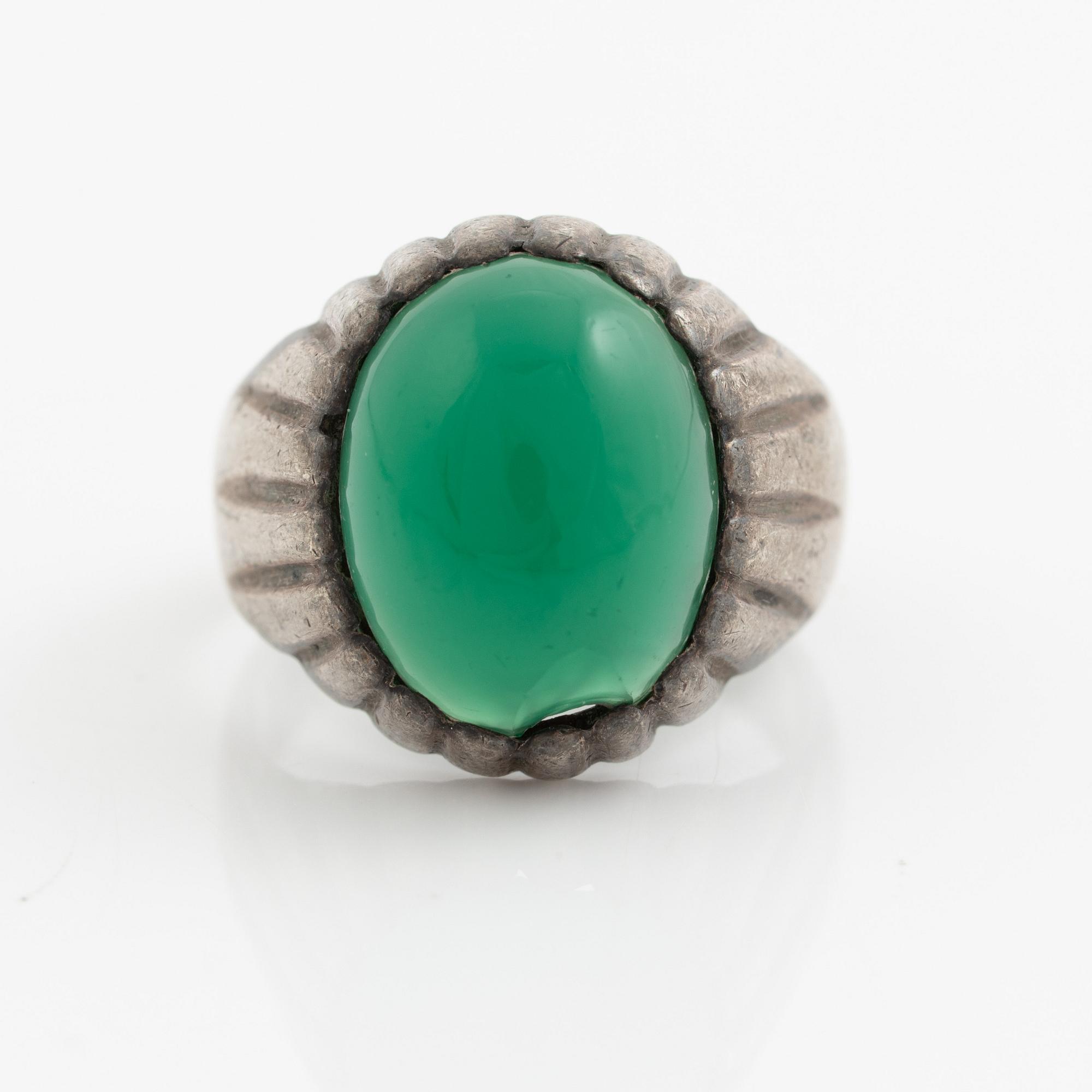 Silver ring with a green cabochon-cut stone.