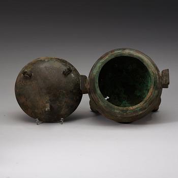 A bronze ding tripod censer with cover, presumably Han dynasty (206 BC - 220 AD).