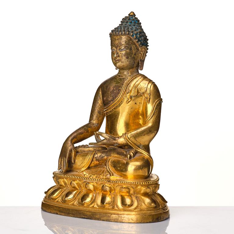 A Tibeto Chinese style gilt copper alloy figure of Buddha.