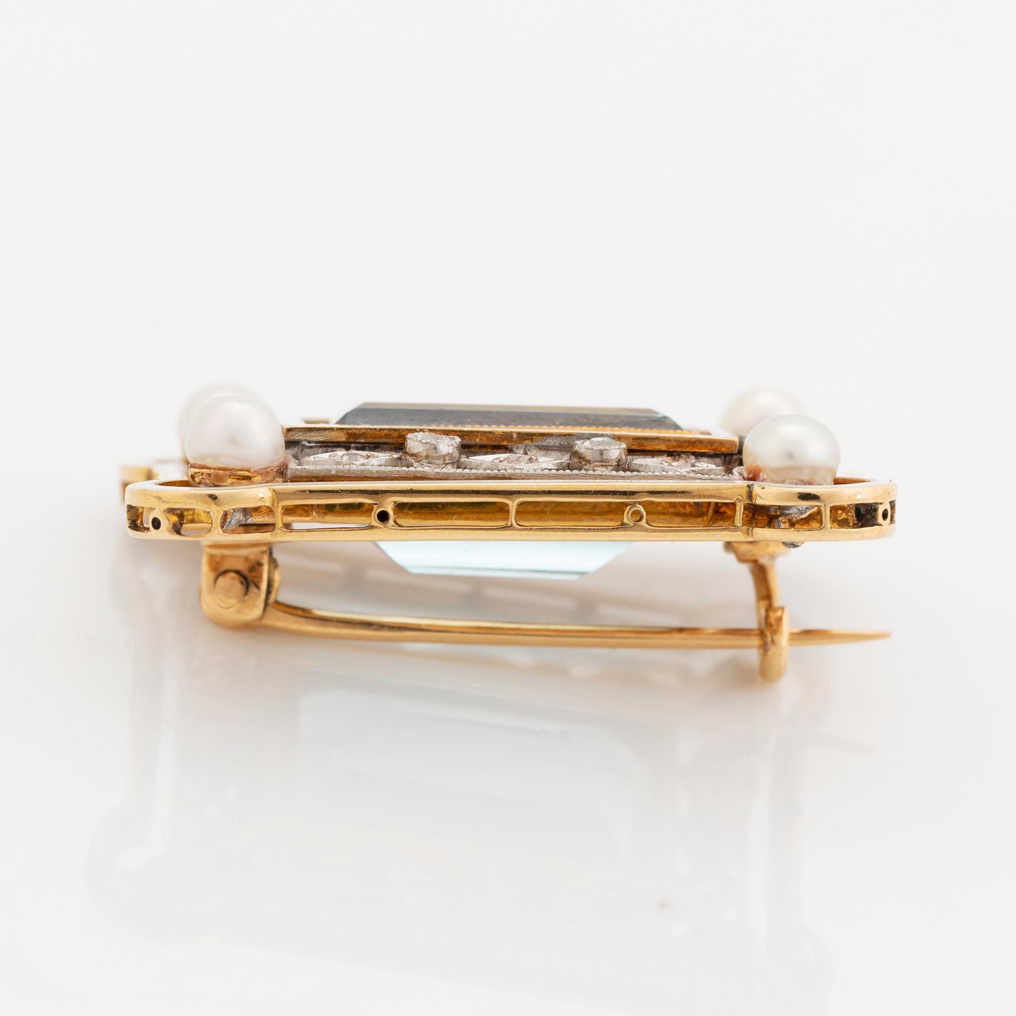 An 18K gold and enamel brooch set with a faceted aquamarine, pearls and old-cut diamonds.