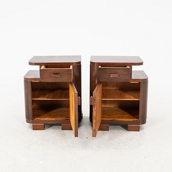 A pair of stained wood bedside tables from the first half of the 20th century.