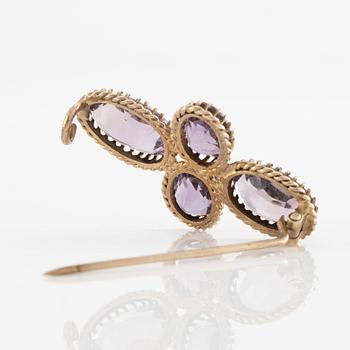 A set with a necklace, a bracelet, a brooch, and a ring.