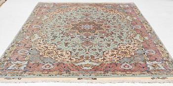 A Tabriz carpet, part silk, approx. 367 x 250 cm.