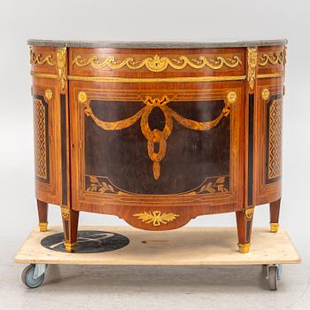 A Gustavian style cabinet with a stone top, 20th century.