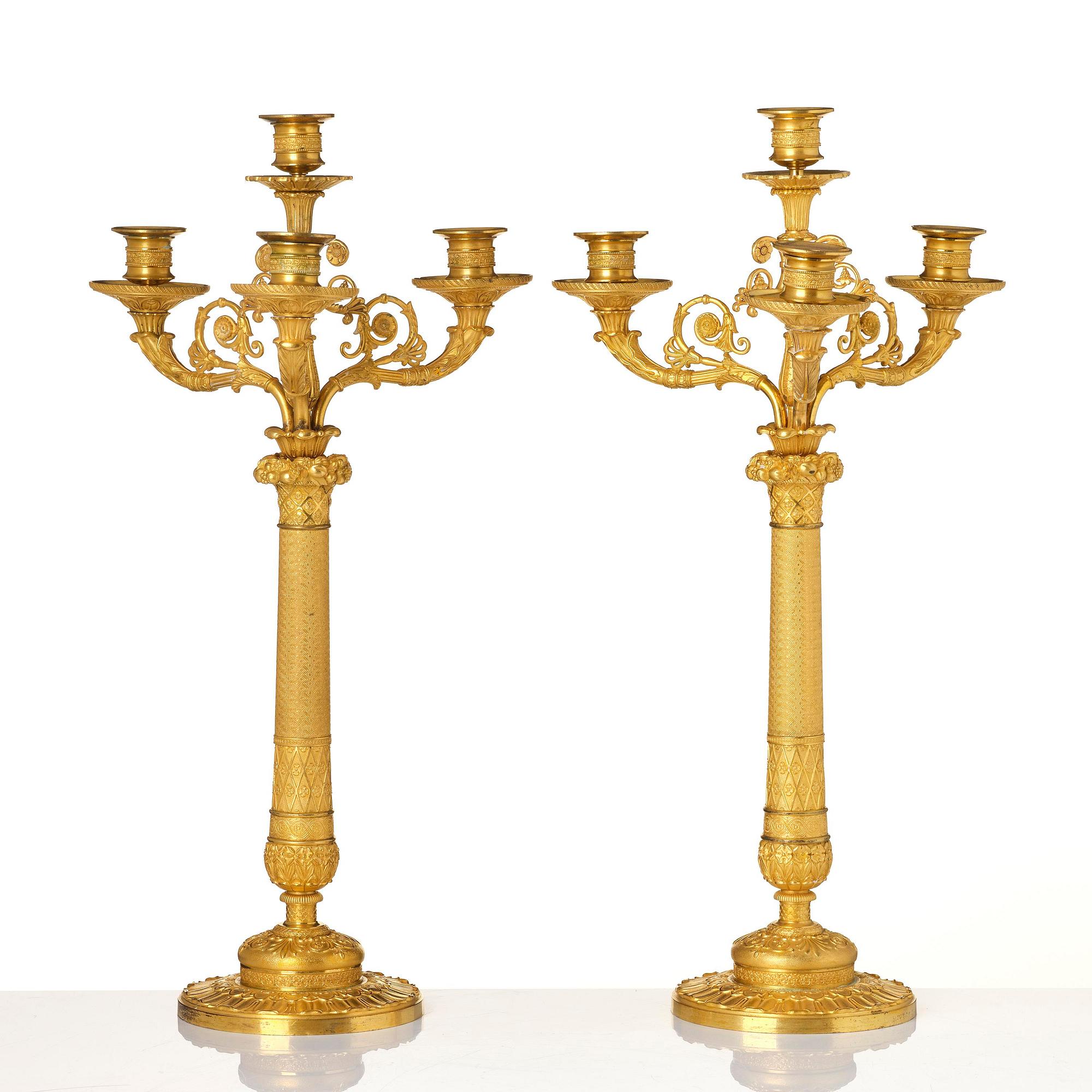 A pair of French Empire four-light gilt bronze candelabra, early 19th century.