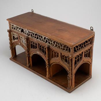 A Gothic style wall shelf, circa 1900.