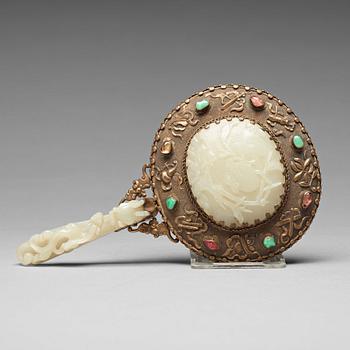 762. A Chinese metal mirror with a large carved nephrite placque and hook, early 20th Century.