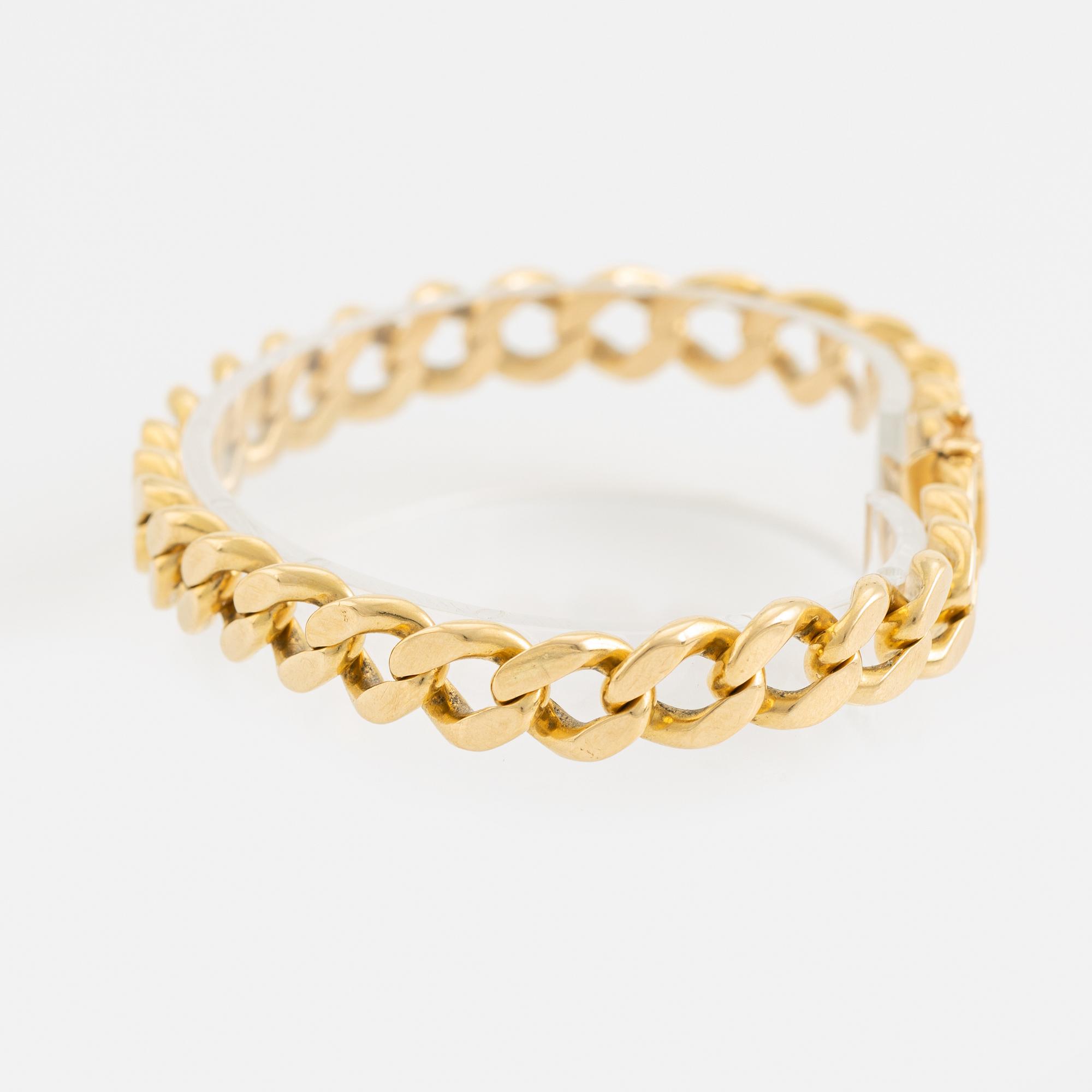 18K gold curb link bracelet.