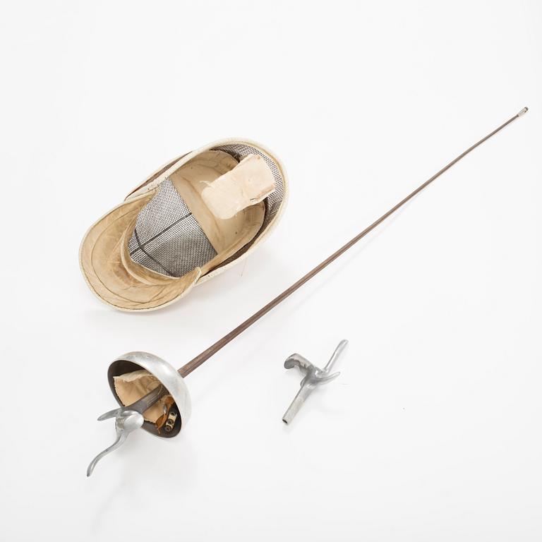 a late 20th century electric epee and a epee fencing mask.