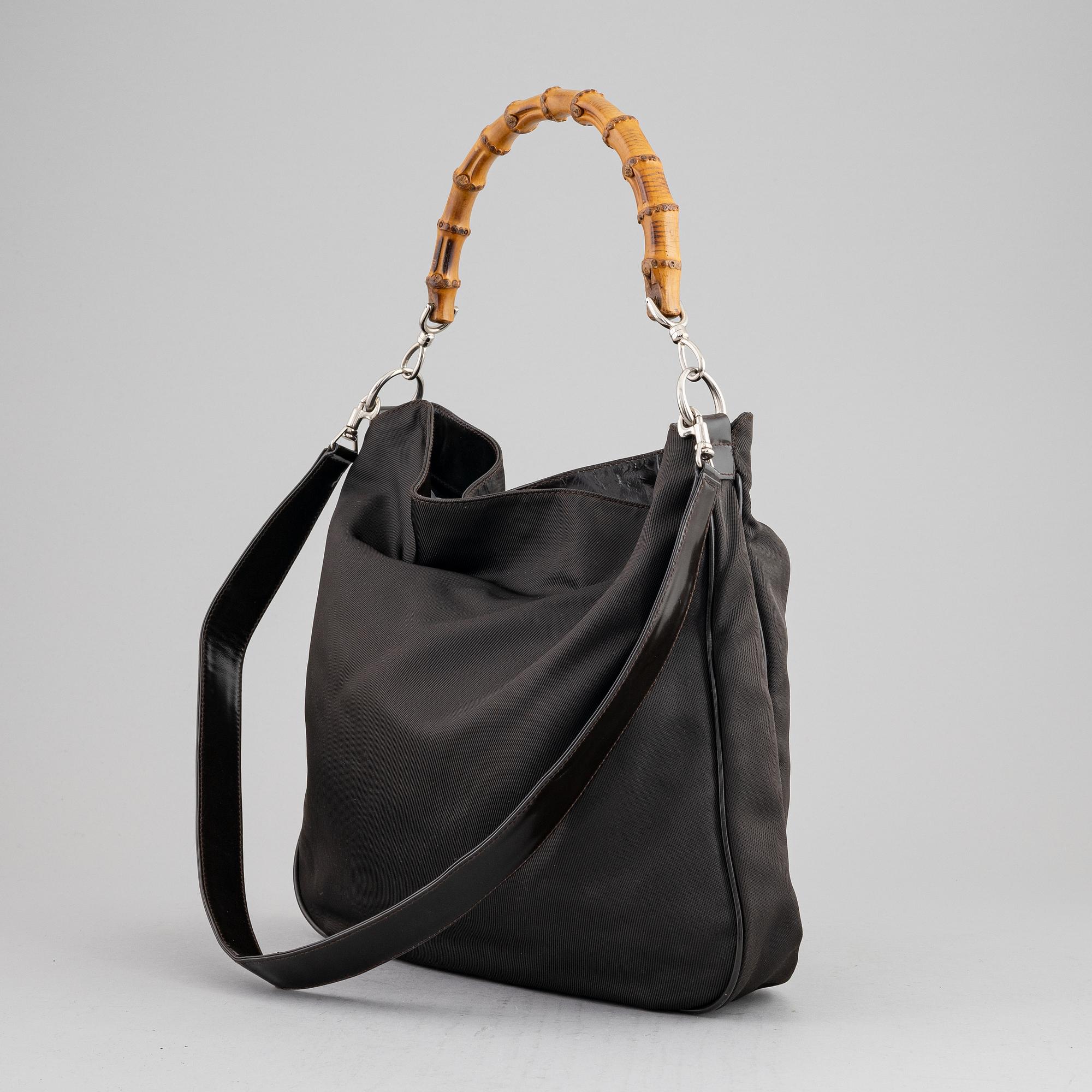 Gucci, a chocolate brown nylon handbag.