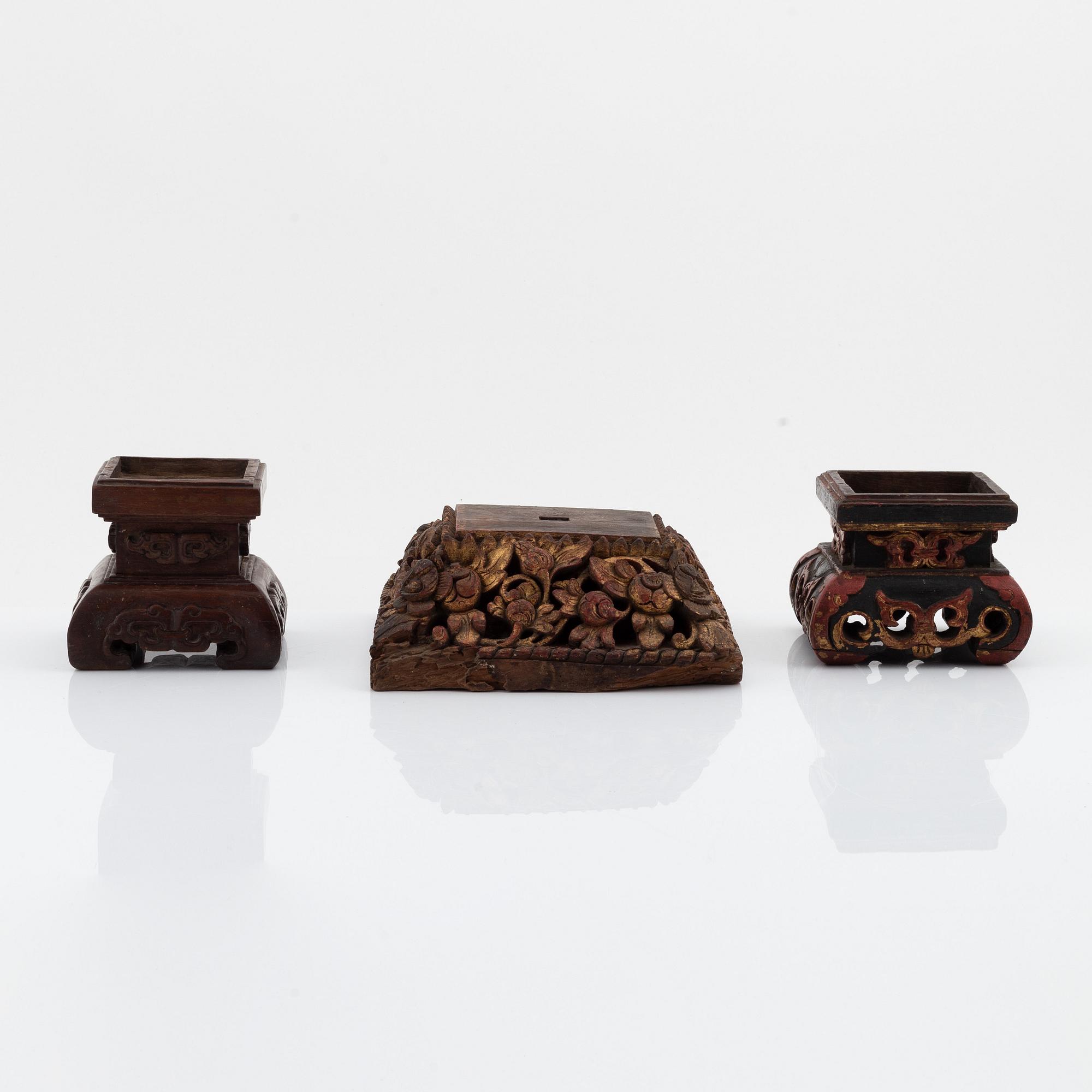 A set of three carved wooden stands, early 20th Century.