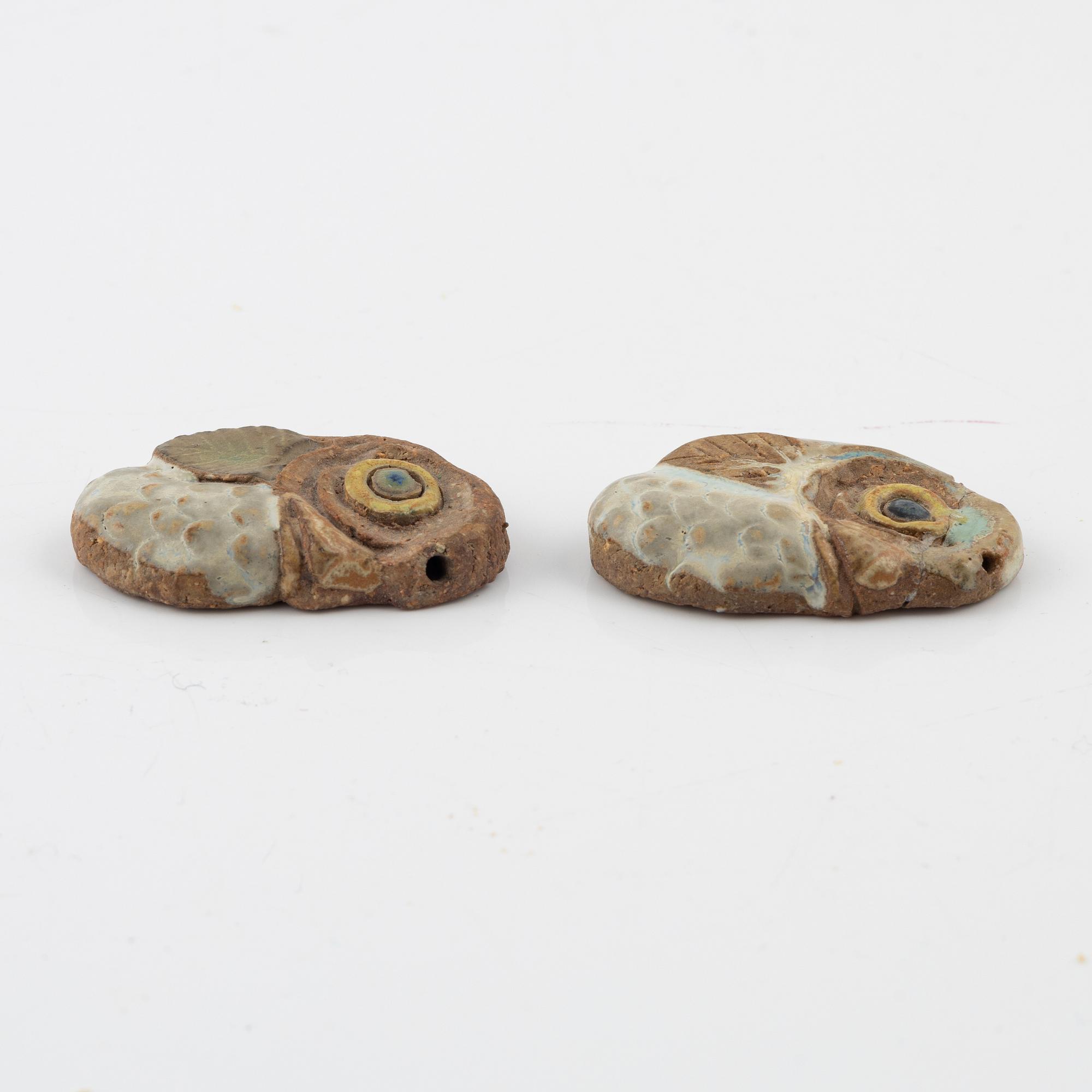 Tyra Lundgren, two stoneware pendants.