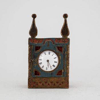 A carved and painted folk art pocket watch case dated 1774.