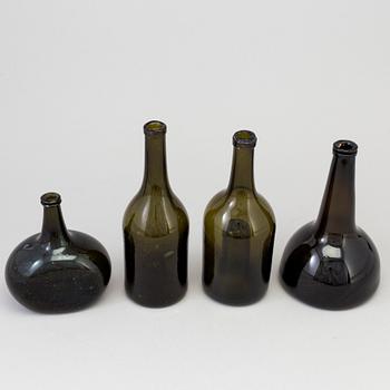 A set of four 18th/19th century hand blown glass bottles.