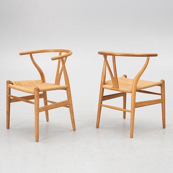 Hans J. Wegner, four model CH-24/ 'Wishbone' chairs, Carl Hansen, Odense, Denmark, second half of the 20th century.