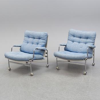 A pair of easy chairs with stool by Bruno Mathsson, DUX, late 20th century.