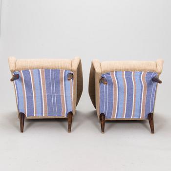 A pair of 1950s armchairs.