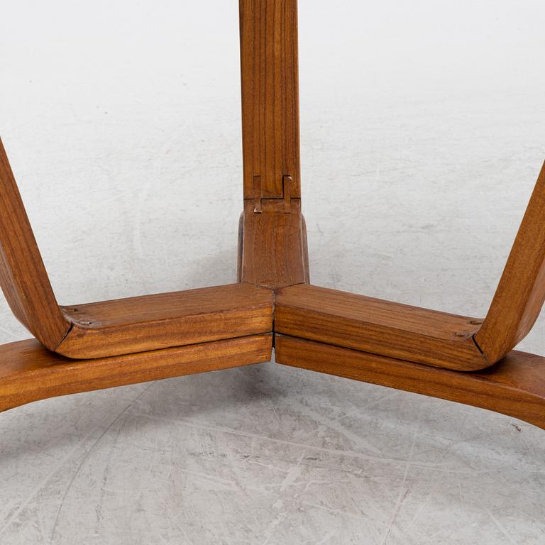 A Swedish Modern coffee table with a glass top. 1940's.