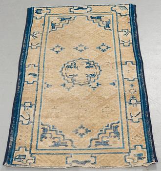 A RUG, an antique Ningxia, China, late Qing, ca 130 x 70,5 cm.