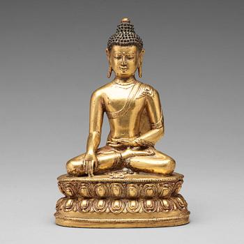 470. A gilt copper alloy figure of Akshobhya, Tibet, 16th Century.