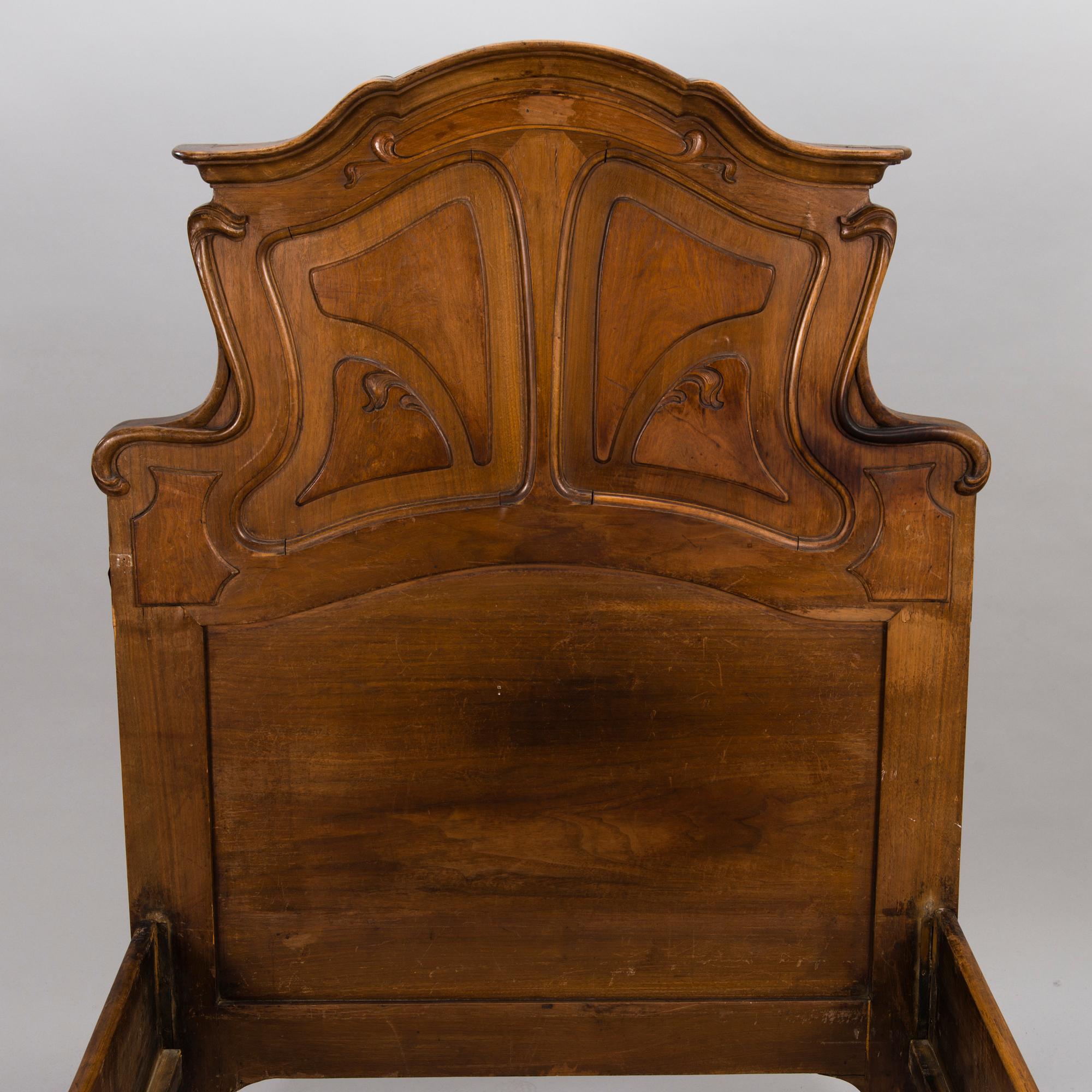 A pair of early 20th Century art nouveau style beds.