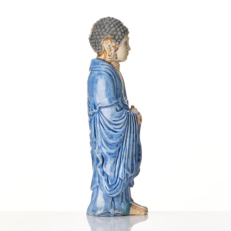 A porcelain figure of a standing Buddha, Qing dynasty, 18th Century.