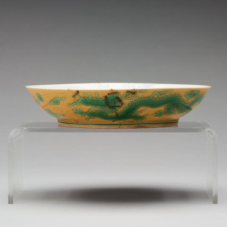 A yellow glazed dish with green five clawed dragons, Qing dynasty, Jiaqings seal mark in underglaze blue (1644-1912).