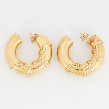 A pair of 18K gold earrings.