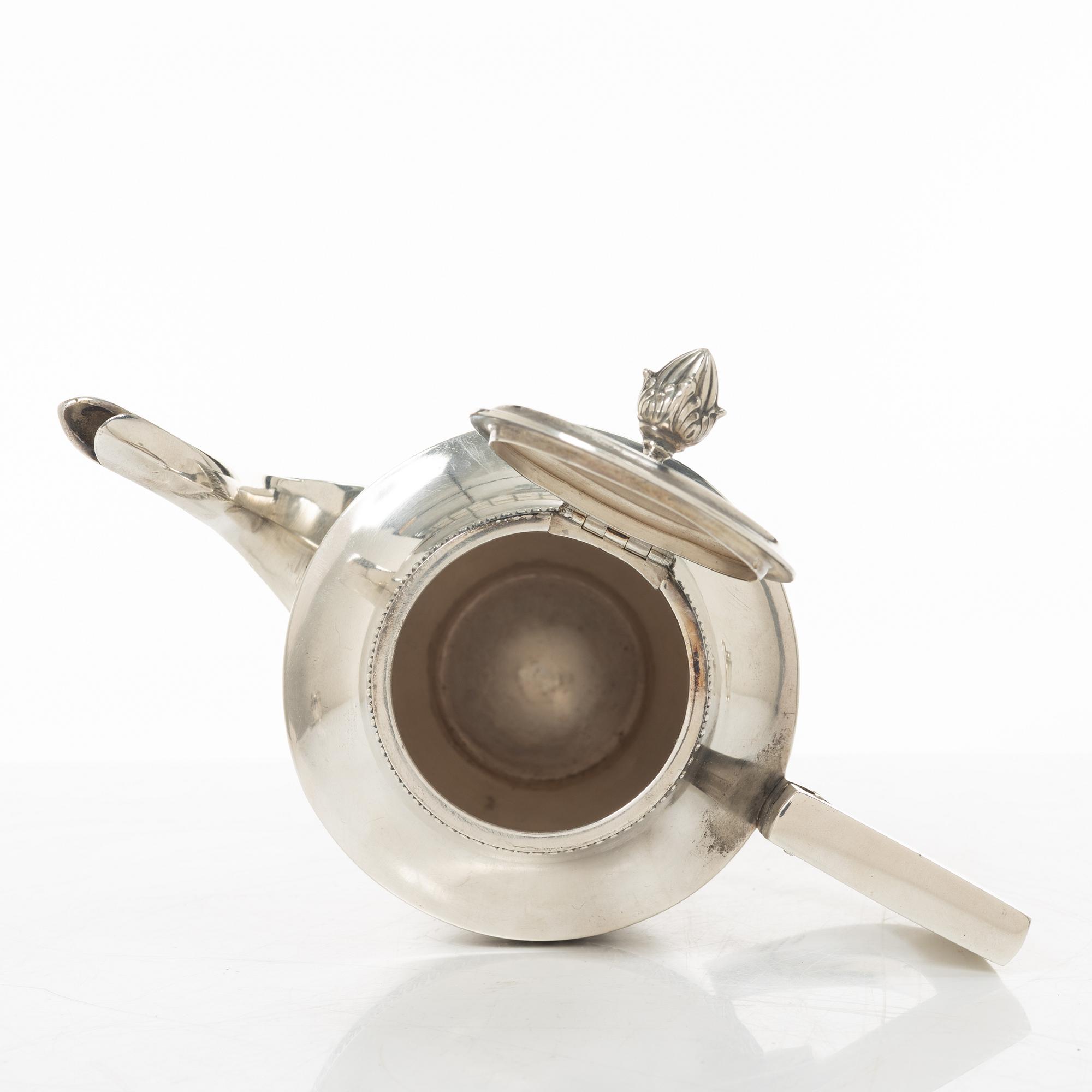 A silver coffee pot, creamer and sugar bowl, import marks of Axel Larson, Helsingborg 1920.