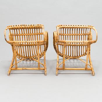 A pair of 1950/60s rattan lounge chairs.