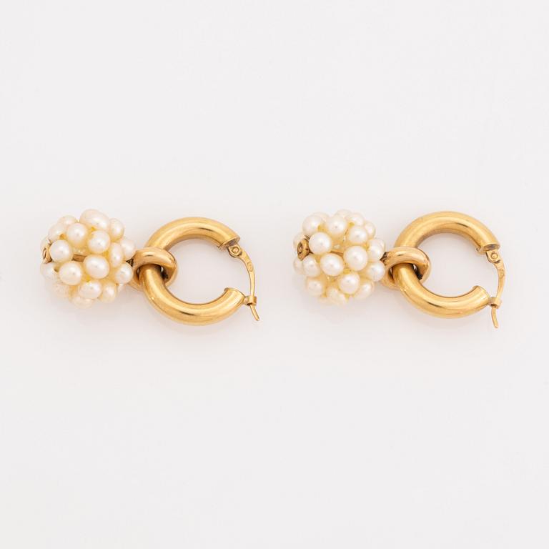Pearl and gold earrings.