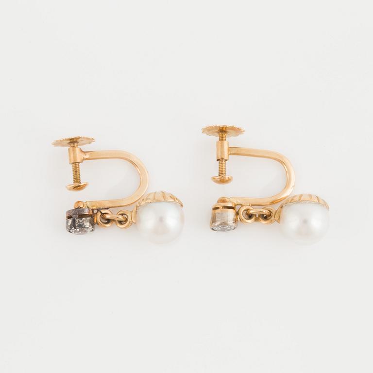 A pair of earrings set with cultured pearls and old-cut diamonds.