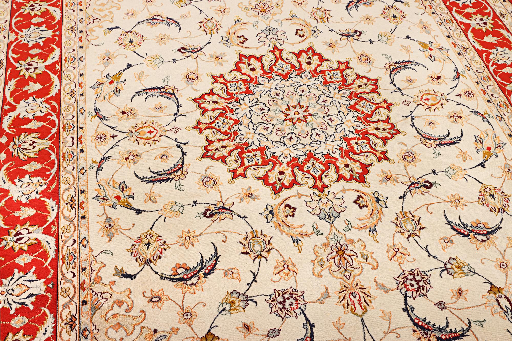 A semi-antique part silk Isfahan rug, a. 238 x 156 cm.