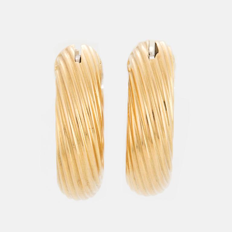 A pair of earring with a turned, fluted pattern.