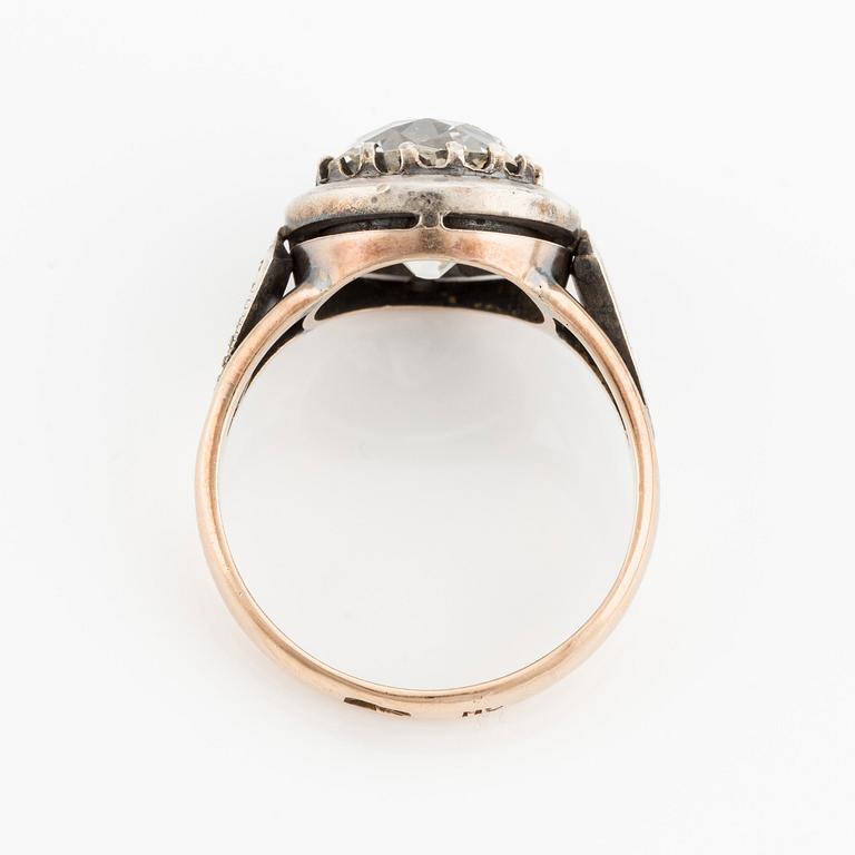 A 14K gold and silver ring with an old-cut diamond.