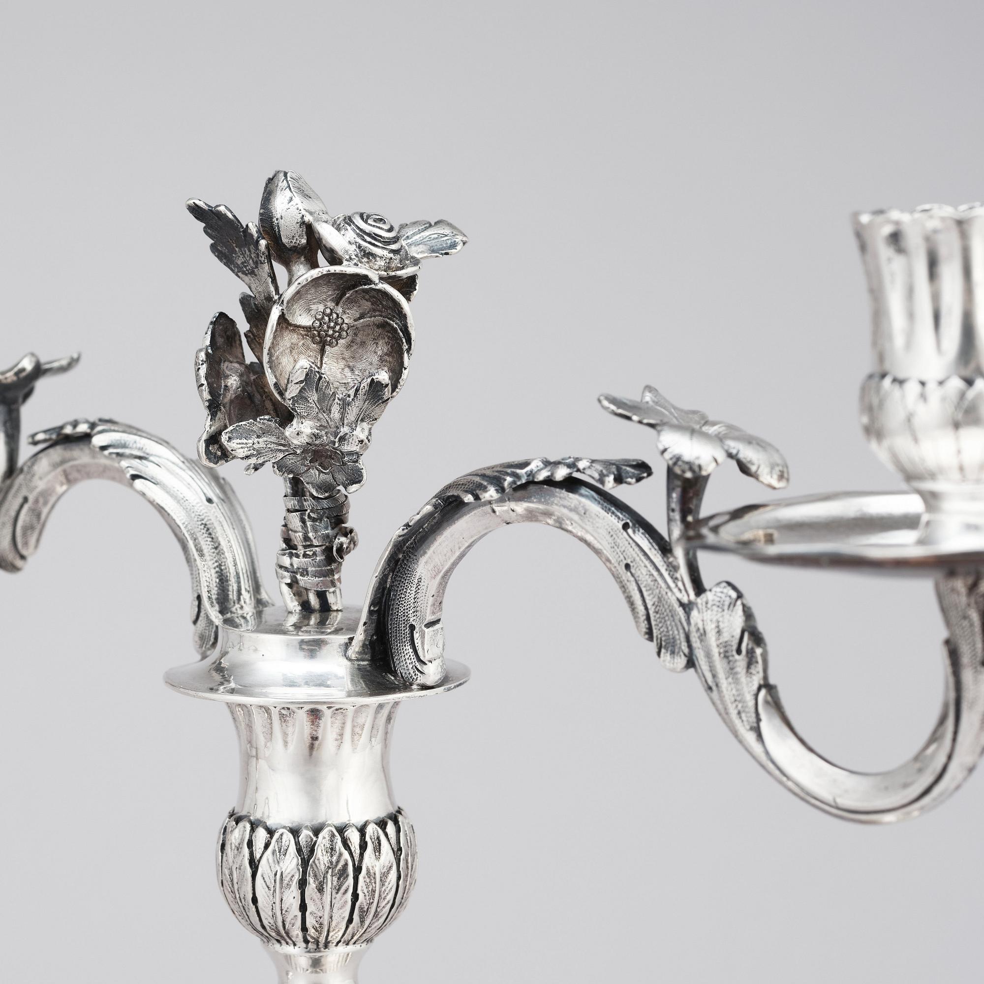 A pair of Swedish 18 century silver candelabras, mark of Lars Åkerblom Gävle 1775, arms by Christian Kullberg.
