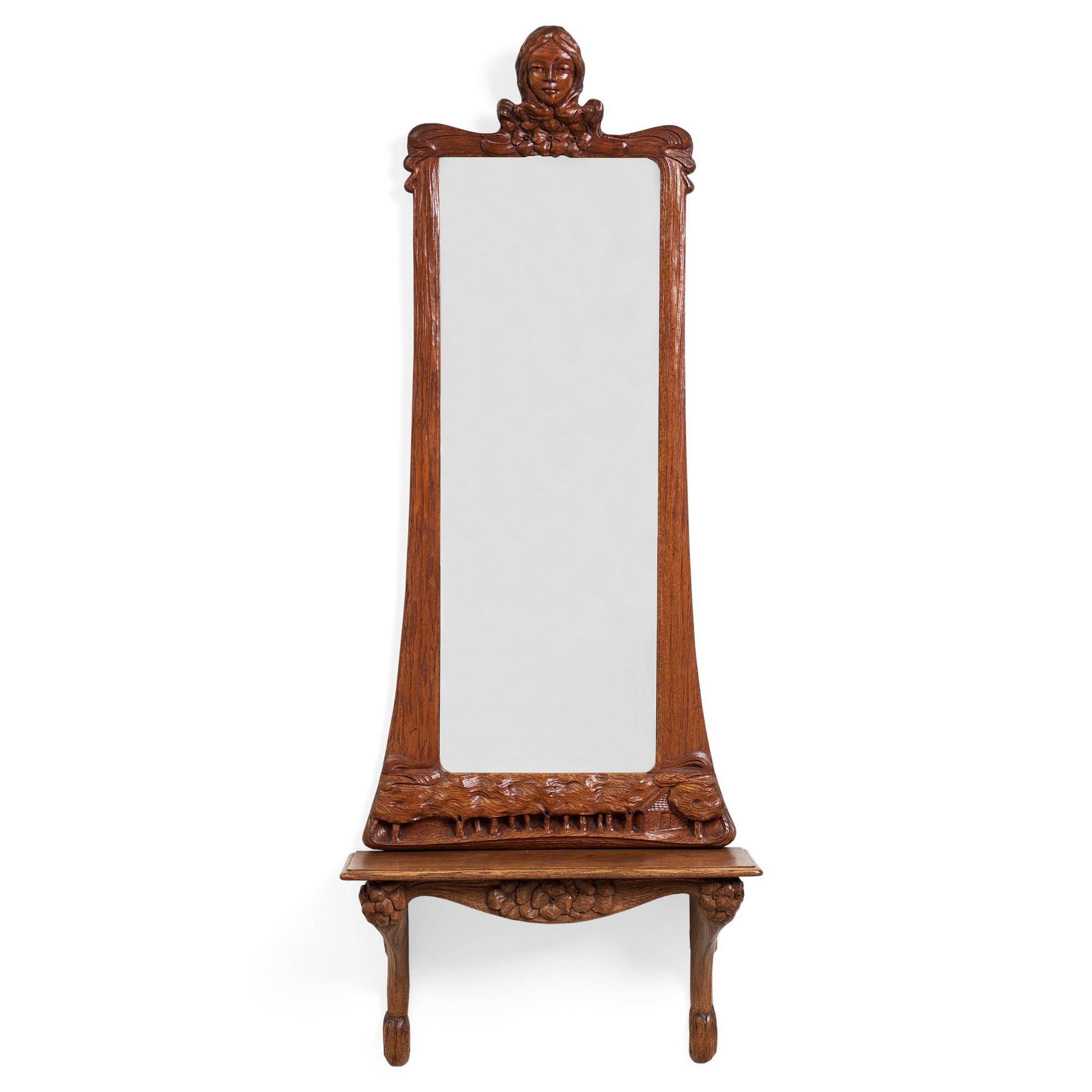 An Art Nouveau oak wall mirror with a console table.
