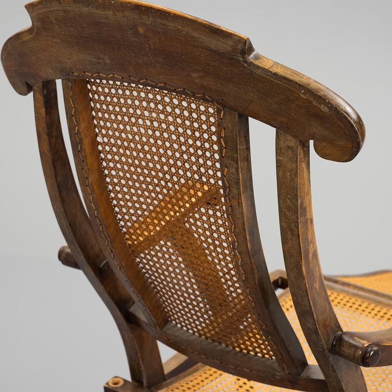 A stained wood and rattan deck chair, first half of 20th century.