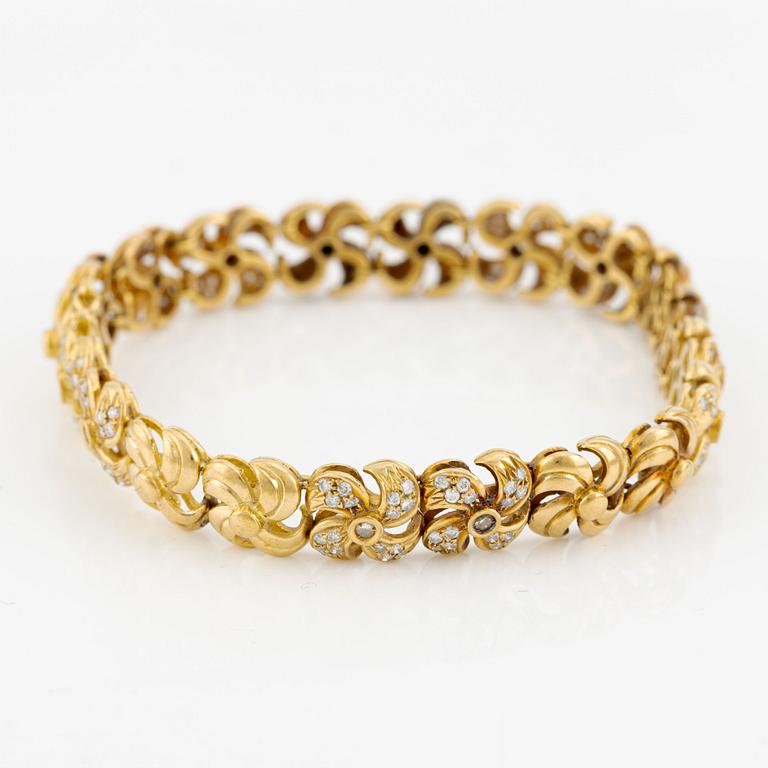 Armlänk, 18K guld med briljantslipade diamanter.