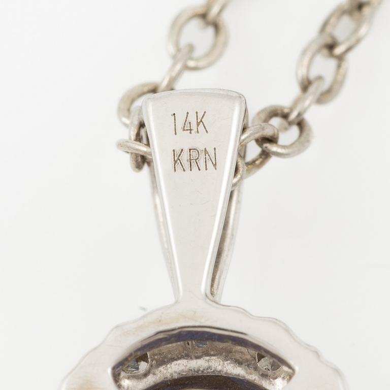 Pendant in 14K white gold set with a faceted tanzanite and round brilliant-cut diamonds.