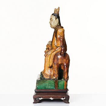 A green and yellow glazed figure of a dignitary and a tiger, Ming dynasty (1368-1644).