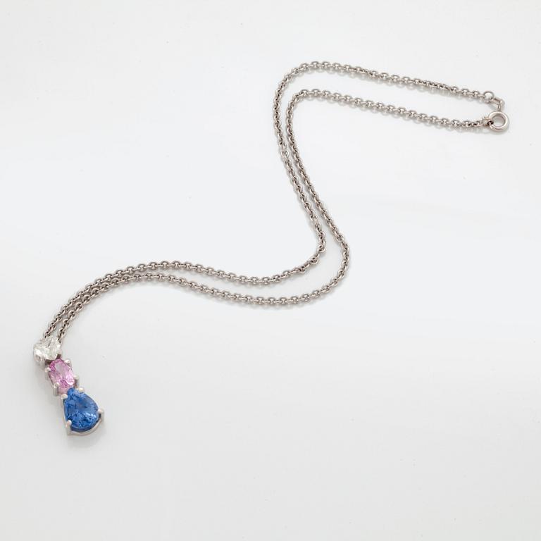 A PENDANT set with sapphires and a heart brilliant-cut diamond.