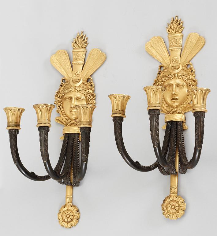 A pair of French Empire three-light wall-lights.