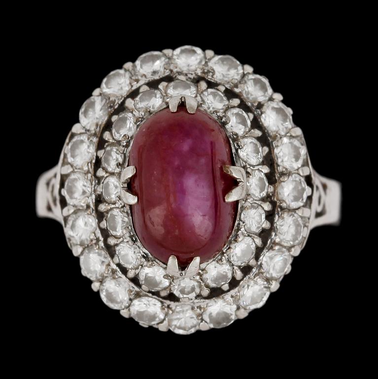 RING, cabochonslipad rubin och briljantslipade diamanter, tot. ca 1.40 ct.