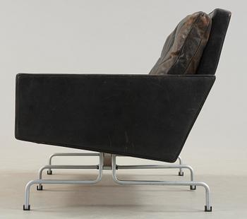 A Poul Kjaerholm 'PK-31-2' steel and black leather sofa, E Kold Christensen, Denmark.