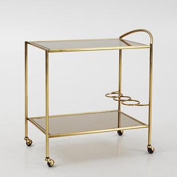 A 1970's glass and brass drinks trolley.