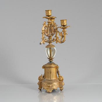 A Louis XVI style mantel clock and a pair of candelabra, circa 1900.