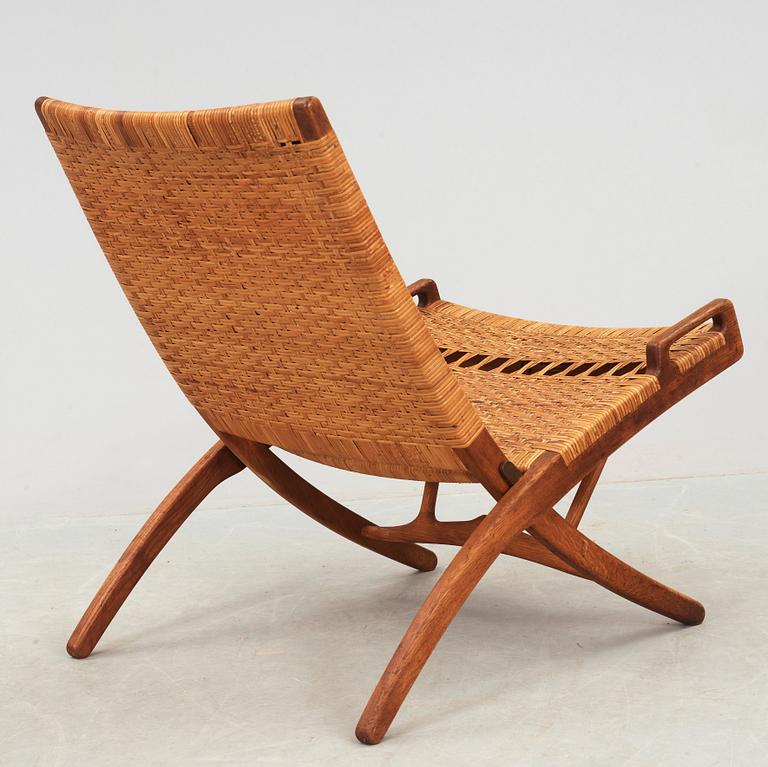 A Hans J Wegner oak and rattan folding chair, by Johannes Hansen, Denmark.