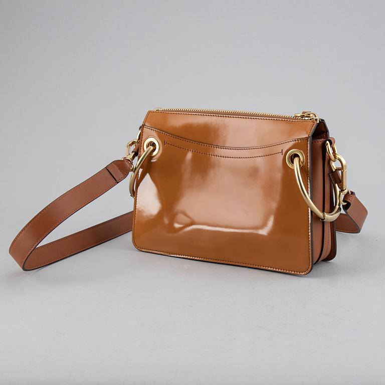 CHLOÉ, a small caramel 'Roy bag'.